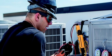 technician servicing HVAC equipment