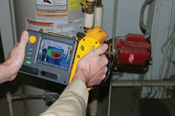 Technician providing thermal imaging services.